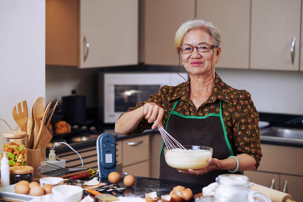 woman whisking an egg for baking