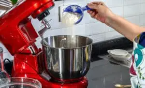 adding ingredients for bread to mixer