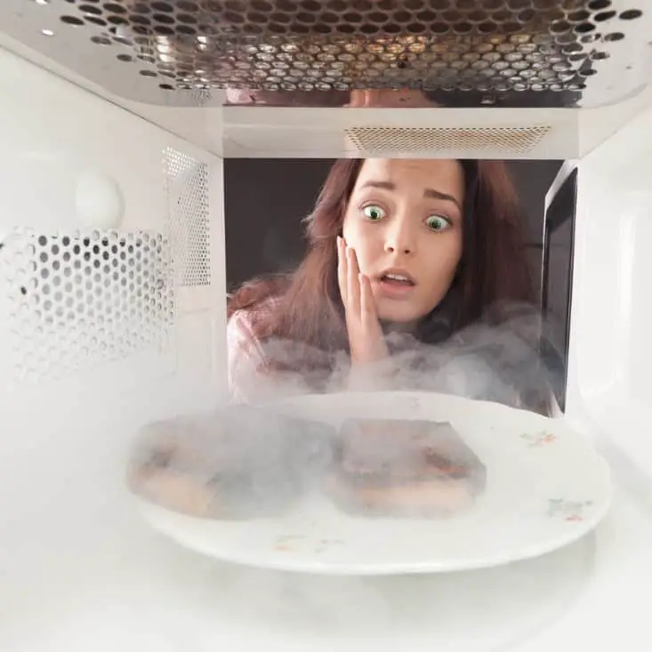 girl burns toast in microwave