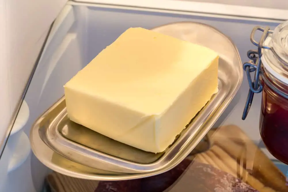 Block of butter sitting on tray in fridge