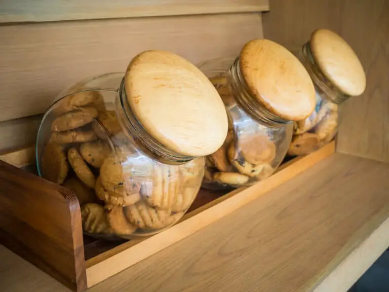 Homemade-cookies-stored-in-glass-jars-on-wooden-shelf