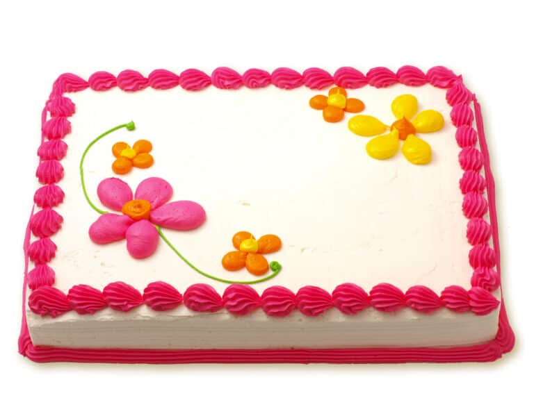 Sheet cake with white icing edged with pink and decorated with flowers