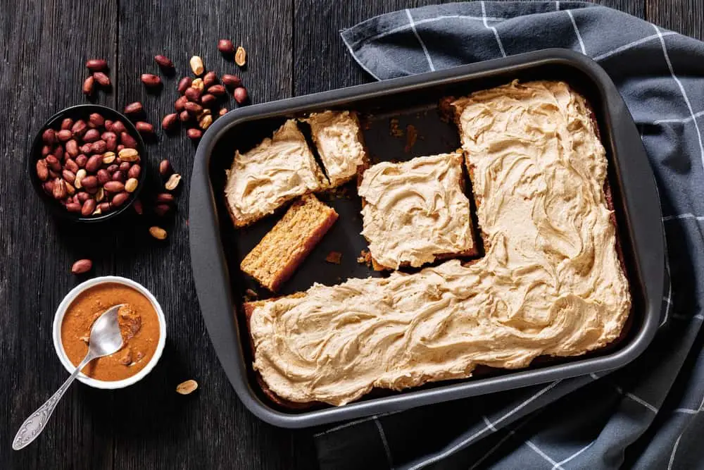 Sliced peanut butter sheet cake with toppings