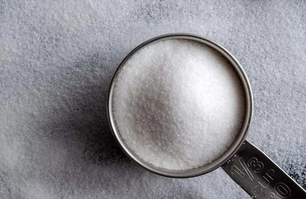 White sugar in measuring cup