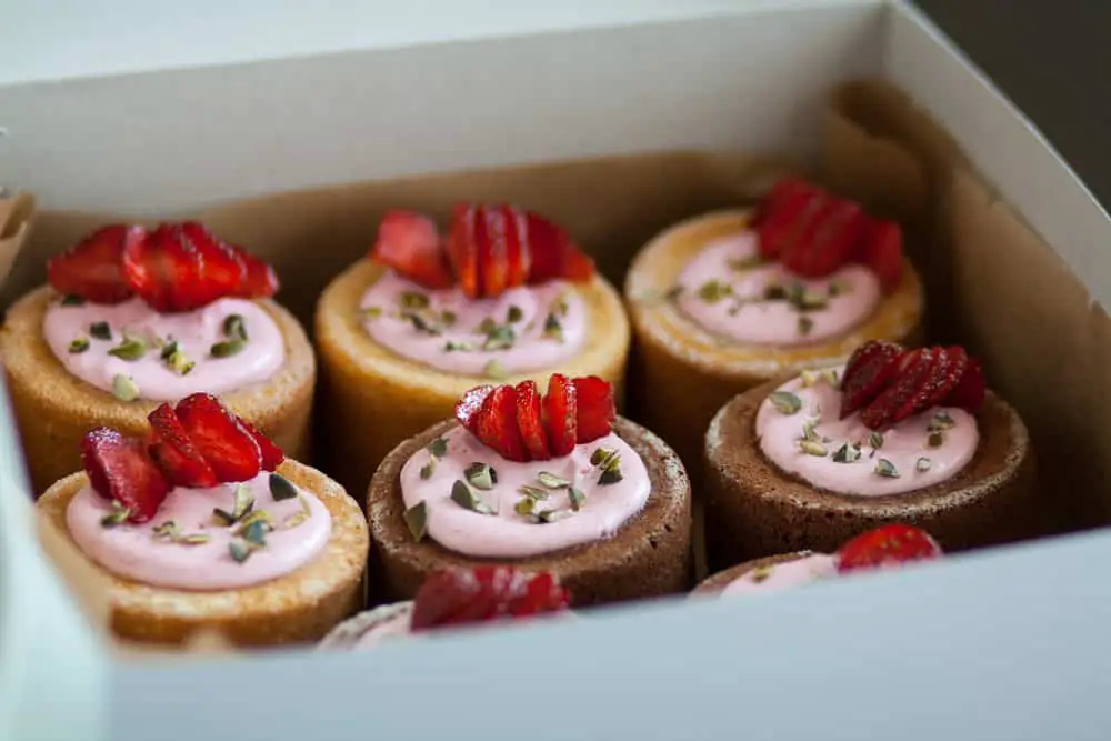 Fruit-topped sweet cakes packaged in a box