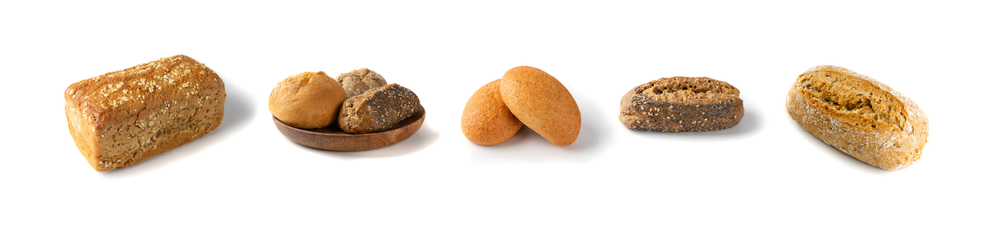 Different types of vegan bread lined up on white background