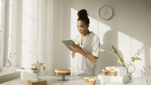 Woman using tablet while baking