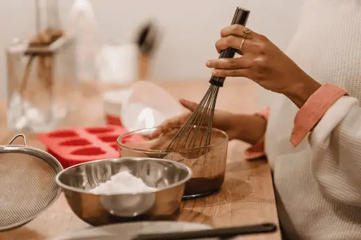 Woman whisking baking ingredients